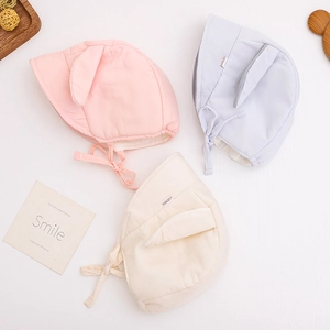 Soft corduroy baby hats with rabbit ears and chin straps in pink, blue, and cream beige