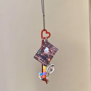 Detail of Hello Kitty themed pendant with red heart clasp and colorful beads