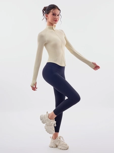 Ensemble de yoga sans couture avec haut zippé jaune pâle et legging de sport bleu foncé