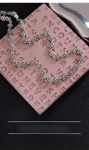 Macro shot of silver-plated copper cross necklace with 46.5cm chain and 20.7g weight