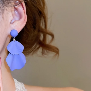 Close-up of lavender petal tassel earrings with a matte texture on a female model