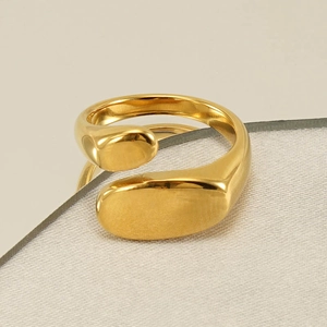 Macro shot of minimalist thick gold-plated irregular ring with smooth polished finish