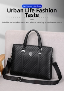 Detail of black leather business briefcase showing embossed texture and metal logo