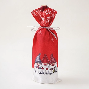 Detail of red Christmas wine bottle bag with gnome prints and white snowflake patterns