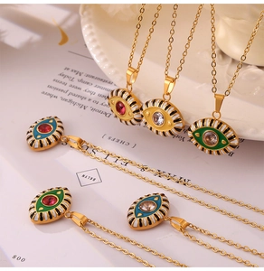 Detailed shot of gold plated evil eye pendants with enamel stripes and zircon inlays