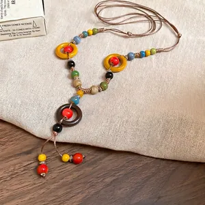 Handcrafted bohemian ceramic bead necklace with colorful resin rings on braided rope