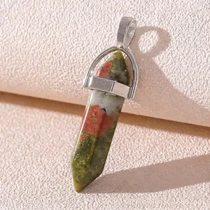 Close-up of hexagonal Unakite stone pendant with silver clasp on white background