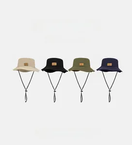 Detail of multi-color wide brim sun hats with adjustable drawstrings in various earthy tones