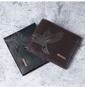 Close-up of eagle pattern embossing on high-quality black and brown men's leather wallets