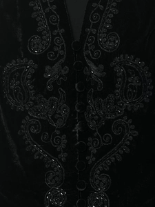 Detail of black velvet vest with intricate beadwork embroidery and covered buttons