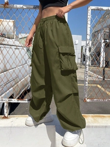 Detail of army green cargo pants featuring elastic drawstring waist and large side pockets