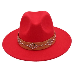 Detailed view of red wool fedora featuring a light brown leather band with silver rivets