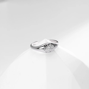 Detailed macro view of S925 sterling silver ring featuring a small cubic zirconia flower