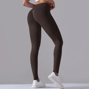 Detail view of seamless high waist yoga leggings in dark brown with peach hip lifting