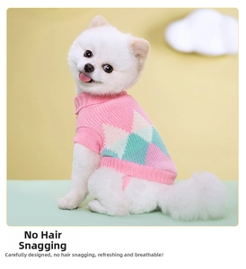 Detailed close-up of pink knit pet sweater featuring mint green diamond pattern weave