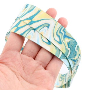 Detailed view of marble pattern lanyard with blue, yellow and green thermal transfer print