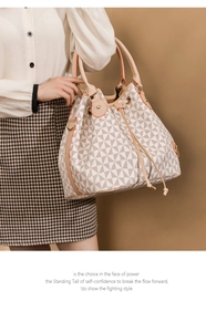 Detail of printed bucket bag showing PVC texture and metal hardware on a female model