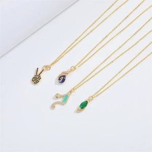 Detail of four gold chain necklaces with peace sign and colorful gemstone pendants