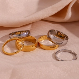 Detailed view of 18K gold and silver plated stainless steel stackable ring set on silk