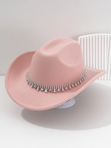Close-up of pink cowboy hat with silver chain, colorful rhinestones and spikes