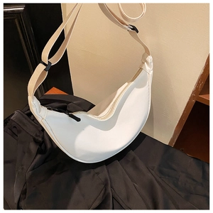 Detailed view of white nylon crescent bag showing the adjustable strap and smooth zipper