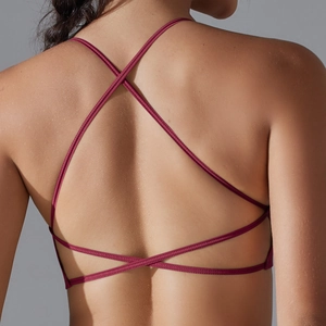Macro view of cross back strap design on burgundy seamless elastic sports bra