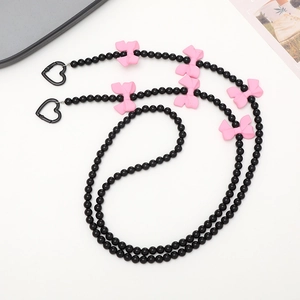 Crossbody phone strap with black beads, pink bows and heart metal clasps on white base