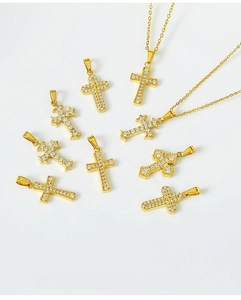 Detailed view of eight gold cross pendants with micro-paved zircons, excluding the chain