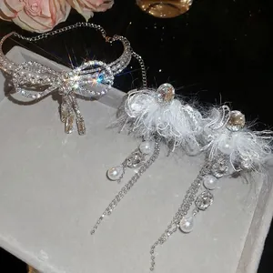 Elegant silver bow jewelry set with shimmering rhinestones, pearls and feather fringe