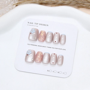 Handmade press-on nails with blue cat-eye finish, floral relief, and pearl accents