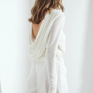 Elegant white backless long sleeve top with draped pleats and matching loose trousers