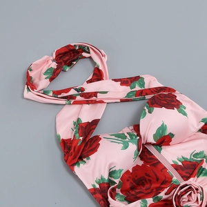 Detail of pink rose print dress featuring a halter neck strap and invisible zipper back