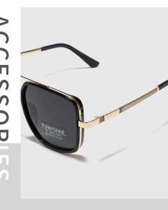 Detail of square sunglasses showing TR90 black frame, gold metal temples, and UV400 lens