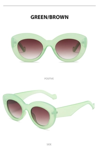 Detail view of retro Y2K cat eye sunglasses in green frame with brown gradient lenses