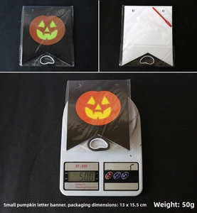 Detail view of small Halloween pumpkin alphabet banner with orange prints and threading needle