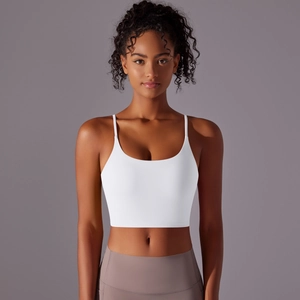 Close-up of white yoga crop top featuring thin straps and slim fit sports fabric