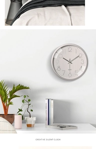 Detail of a 12 inch minimalist silent quartz wall clock in a modern home office setting