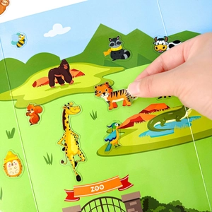 Close-up of interactive zoo animal stickers showing a hand peeling a cartoon tiger sticker