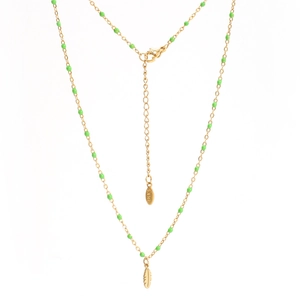 Detail of stainless steel gold chain necklace featuring green beads and feather pendant