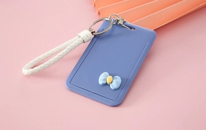 Blue cartoon card holder featuring a white braided wrist strap and decorative bow tie