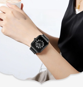 Close-up of a women's square quartz watch with black silicone strap and Roman numerals