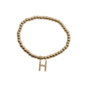 Minimalist gold bead bracelet featuring a colorful zircon micro-pave H letter charm