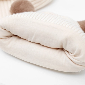 Detail of soft knit lining and contrast fur pompom on children's winter beanie