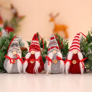 Set of 4 festive knitted Christmas gnome ornaments with red and grey hats on tree