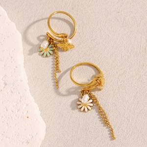 Detail of 18K gold plated ring with blue daisy charms, bee pendant and tassel chains