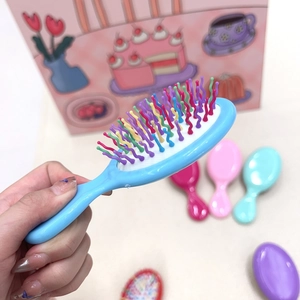 Mini portable hairbrush with colorful wavy bristles and blue handle for kids travel