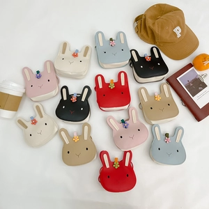 Flat lay of colorful cartoon rabbit mini crossbody bags for kids in various soft pastel tones