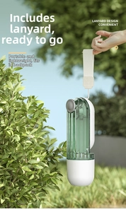 Close-up of portable pet water bottle with lanyard design against a natural green background