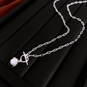 Detailed close-up of silver OT buckle necklace with a single faux pearl pendant