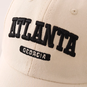 Beige kids cotton baseball cap with black Atlanta embroidery and curved brim for sun protection